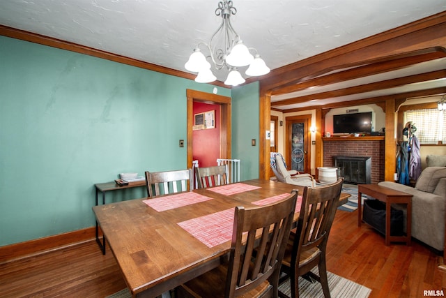 1926 W Callender Ave, West Peoria, IL 61604 - dining room with a chandelier, a fireplace, and wood finished floors