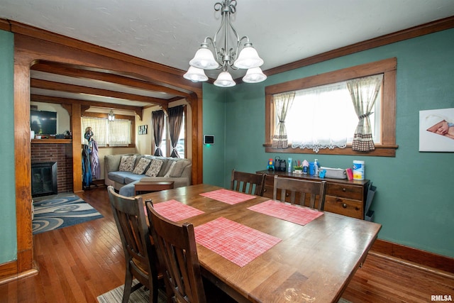 1926 W Callender Ave, West Peoria, IL 61604 - dining space with a chandelier, hardwood / wood-style flooring, and a brick fireplace