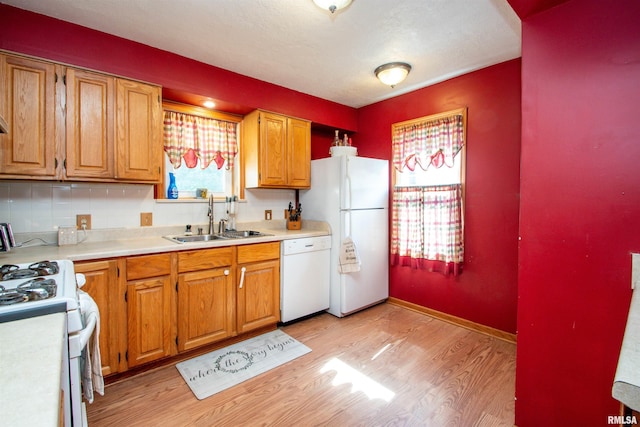 1926 W Callender Ave, West Peoria, IL 61604 - kitchen with white appliances, light wood-style floors, light countertops, and brown cabinets