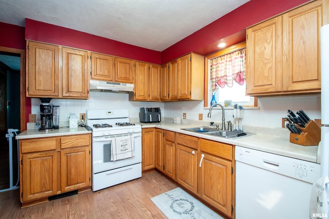 1926 W Callender Ave, West Peoria, IL 61604 - kitchen featuring white appliances, under cabinet range hood, decorative backsplash, light wood-style floors, and light countertops