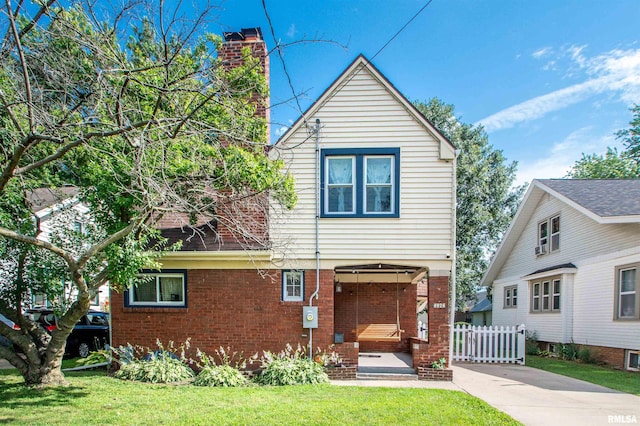 1926 W Callender Ave, West Peoria, IL 61604 - view of front facade with a front lawn, brick siding, and a chimney