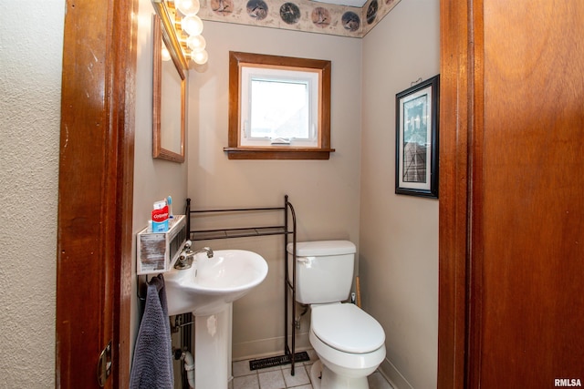 1926 W Callender Ave, West Peoria, IL 61604 - half bathroom with toilet and tile patterned flooring