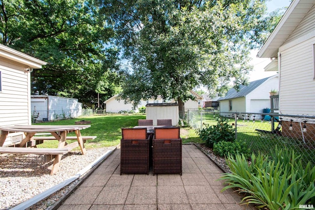 1926 W Callender Ave, West Peoria, IL 61604 - fenced backyard featuring outdoor dining space, a storage shed, and a patio