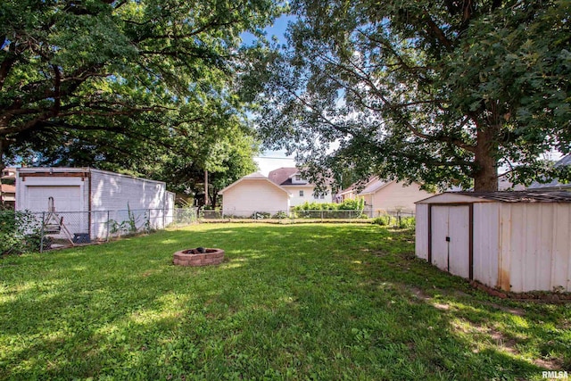 1926 W Callender Ave, West Peoria, IL 61604 - fenced backyard with an outdoor fire pit and a storage shed