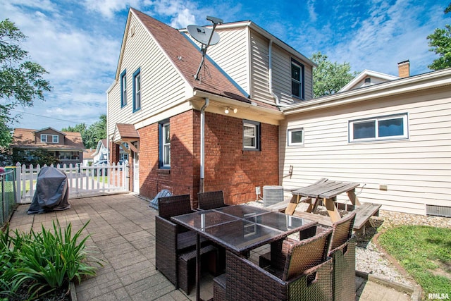 1926 W Callender Ave, West Peoria, IL 61604 - back of house with a patio, outdoor dining area, and brick siding