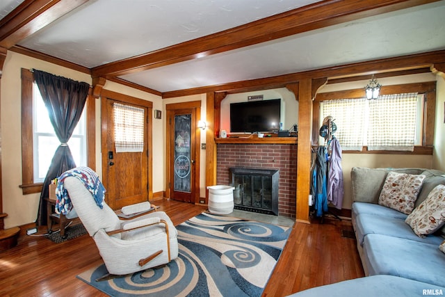 1926 W Callender Ave, West Peoria, IL 61604 - living area featuring wood finished floors, beamed ceiling, plenty of natural light, and a fireplace