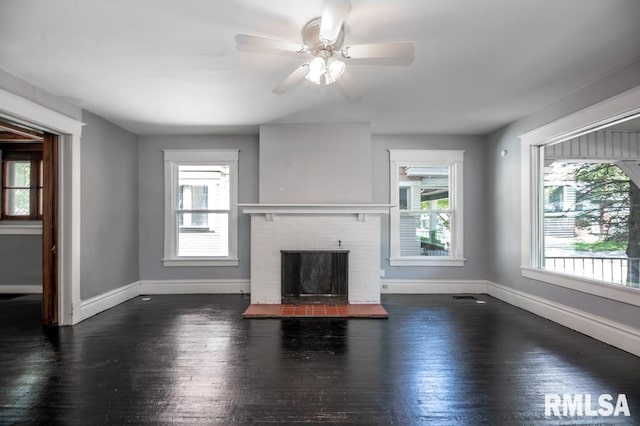1121 N University St, Peoria, IL 61606 - unfurnished living room featuring hardwood / wood-style flooring, a fireplace, and a ceiling fan