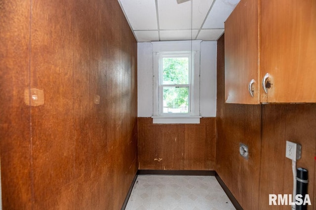 1121 N University St, Peoria, IL 61606 - interior space featuring tile patterned floors, a paneled ceiling, wood walls, and wainscoting