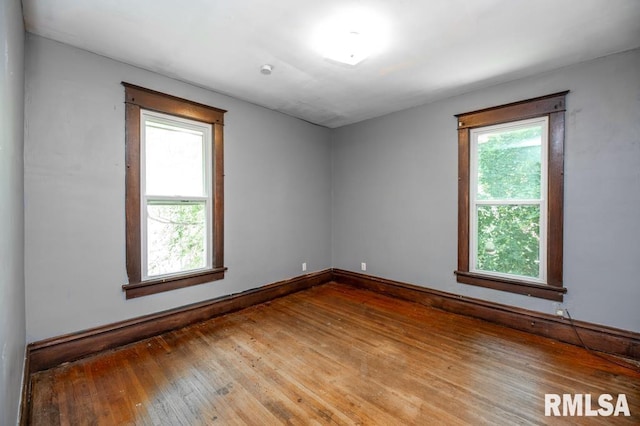 1121 N University St, Peoria, IL 61606 - empty room featuring hardwood / wood-style flooring and baseboards