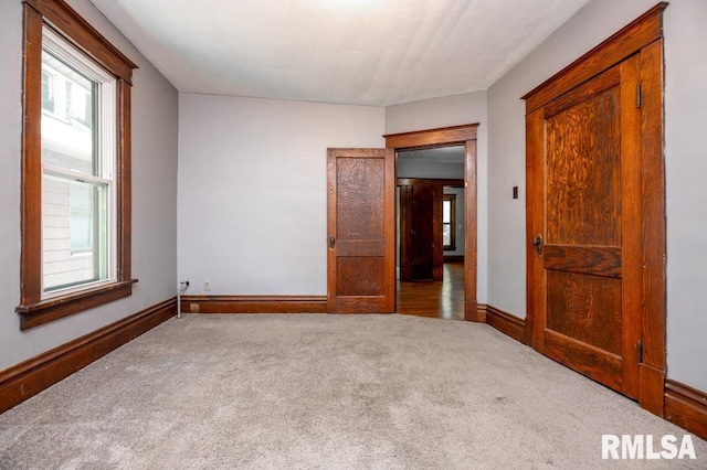 1121 N University St, Peoria, IL 61606 - carpeted empty room with baseboards
