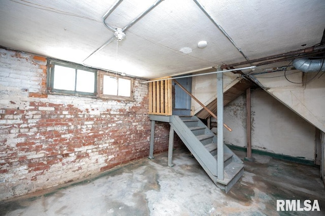 1121 N University St, Peoria, IL 61606 - basement featuring brick wall and stairway