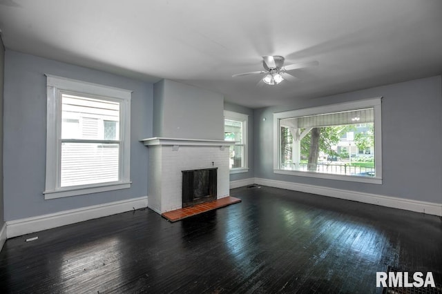 1121 N University St, Peoria, IL 61606 - unfurnished living room with a brick fireplace, hardwood / wood-style floors, and ceiling fan
