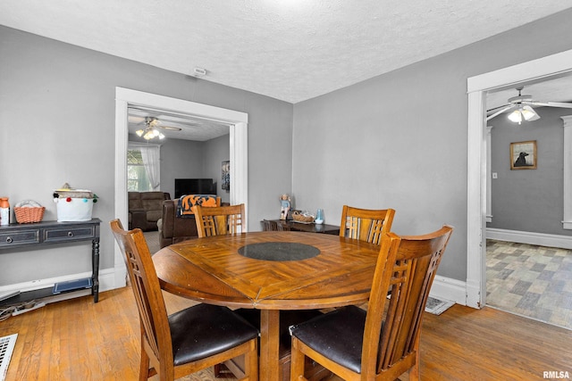 1029 N Santa Fe Ave, Chillicothe, IL 61523 - dining room featuring ceiling fan, wood finished floors, and a textured ceiling