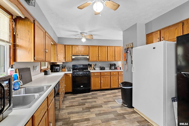 1029 N Santa Fe Ave, Chillicothe, IL 61523 - kitchen featuring black appliances, ceiling fan, light wood finished floors, under cabinet range hood, and brown cabinets