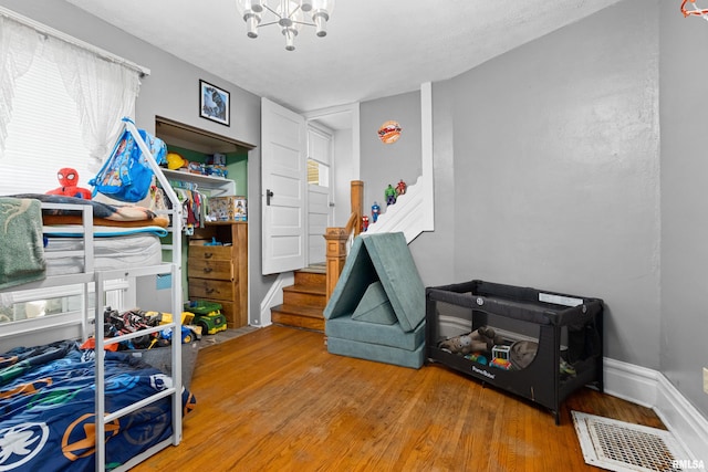 1029 N Santa Fe Ave, Chillicothe, IL 61523 - bedroom featuring a chandelier and wood finished floors