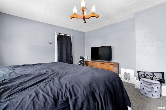 1029 N Santa Fe Ave, Chillicothe, IL 61523 - carpeted bedroom with a chandelier and a textured ceiling