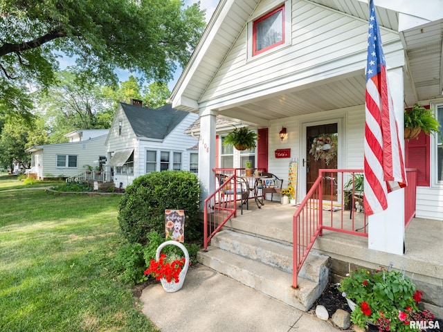 1108 Summer St, Pekin, IL 61554 - view of front of house featuring covered porch and a front yard