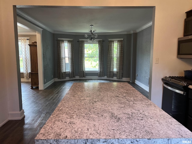 236 W Grant St, Macomb, IL 61455 - kitchen featuring ornamental molding, stainless steel appliances, light countertops, dark wood-type flooring, and a chandelier