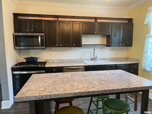 236 W Grant St, Macomb, IL 61455 - kitchen with stainless steel appliances, dark brown cabinets, dark wood-style flooring, backsplash, and ornamental molding