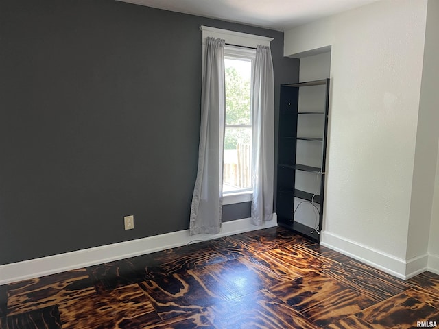 236 W Grant St, Macomb, IL 61455 - unfurnished room featuring baseboards and dark wood-style flooring