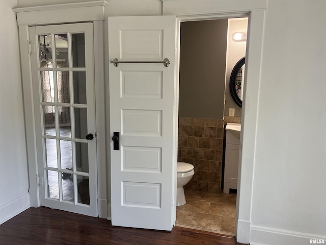 236 W Grant St, Macomb, IL 61455 - half bath featuring tile walls, vanity, and a wainscoted wall