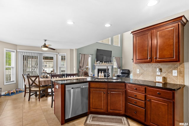 824 Debates St, Washington, IL 61571 - kitchen featuring dishwasher, a ceiling fan, a peninsula, a fireplace, and tasteful backsplash