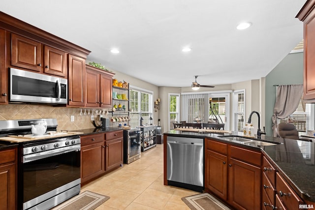 824 Debates St, Washington, IL 61571 - kitchen with appliances with stainless steel finishes, backsplash, light tile patterned floors, ceiling fan, and recessed lighting