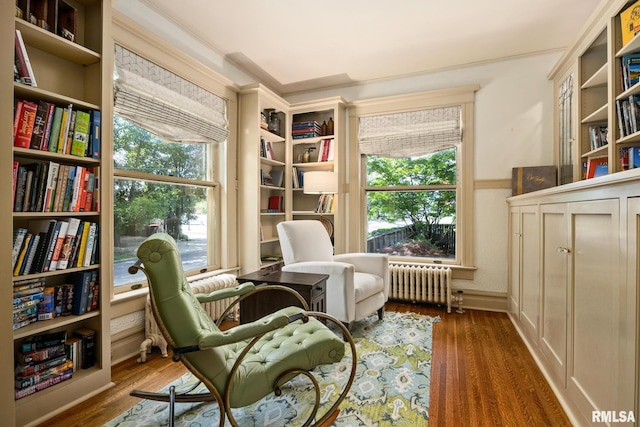 1227 W Barker Ave, Peoria, IL 61606 - sitting room featuring radiator, wood finished floors, and crown molding