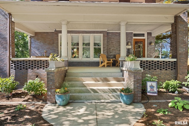 1227 W Barker Ave, Peoria, IL 61606 - doorway to property with covered porch and brick siding