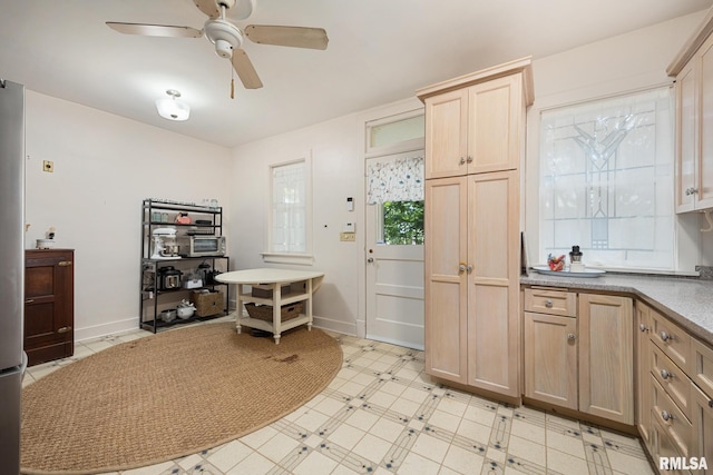1227 W Barker Ave, Peoria, IL 61606 - kitchen with ceiling fan, light floors, light brown cabinetry, and light countertops