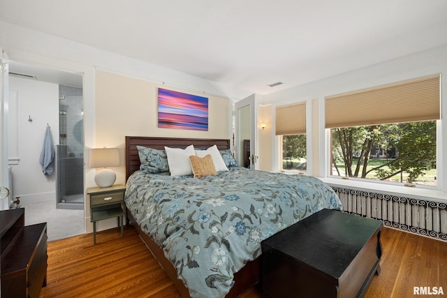 1227 W Barker Ave, Peoria, IL 61606 - bedroom featuring radiator heating unit and wood finished floors