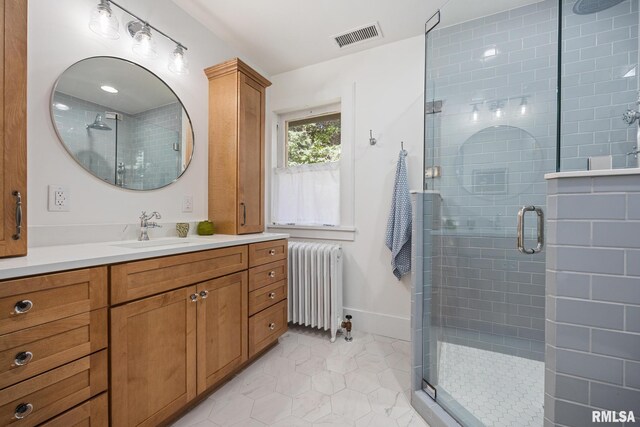1227 W Barker Ave, Peoria, IL 61606 - bathroom with radiator heating unit, vanity, a shower stall, and tile patterned floors