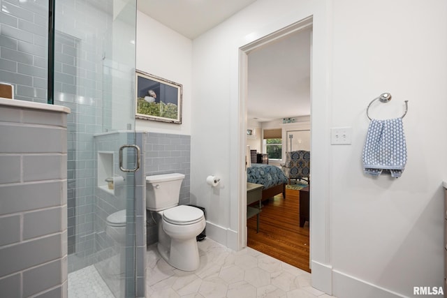 1227 W Barker Ave, Peoria, IL 61606 - full bath with a shower stall, ensuite bath, tile walls, and wainscoting