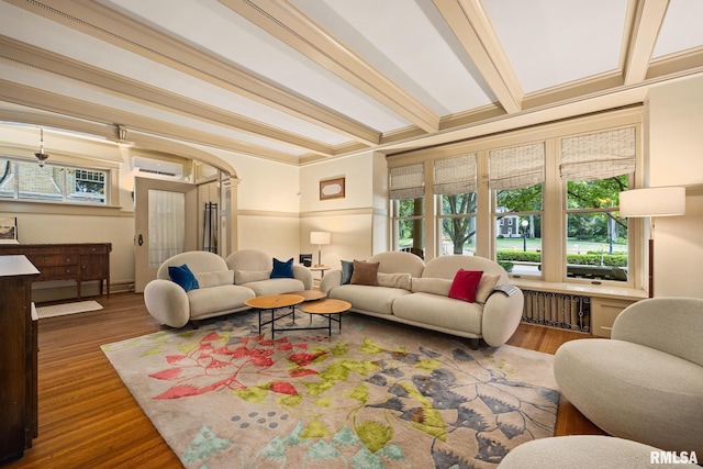 1227 W Barker Ave, Peoria, IL 61606 - living area featuring an AC wall unit, healthy amount of natural light, wood finished floors, beam ceiling, and arched walkways