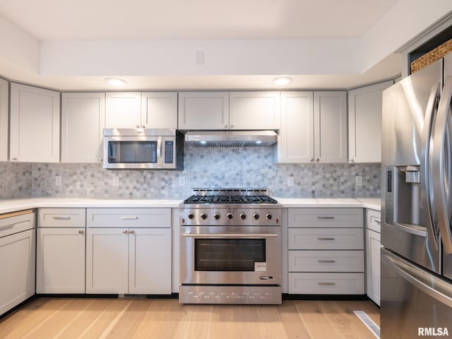 2810 Deveron Cir, Pekin, IL 61554 - kitchen featuring appliances with stainless steel finishes, gray cabinetry, ventilation hood, light wood-style flooring, and light countertops