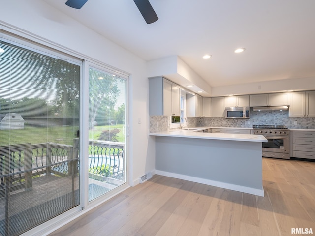 2810 Deveron Cir, Pekin, IL 61554 - kitchen with stainless steel appliances, gray cabinetry, under cabinet range hood, light countertops, and light wood-style floors