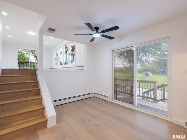 2810 Deveron Cir, Pekin, IL 61554 - spare room featuring baseboard heating, ceiling fan, stairs, light wood finished floors, and recessed lighting