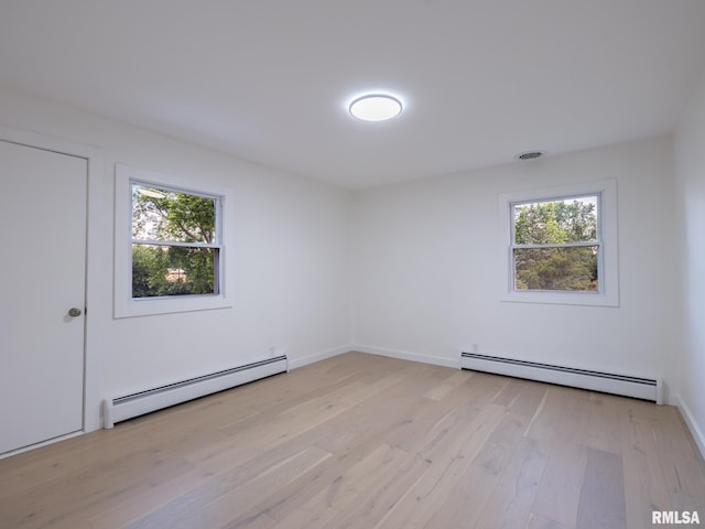 2810 Deveron Cir, Pekin, IL 61554 - unfurnished room with baseboard heating, plenty of natural light, and light wood-type flooring