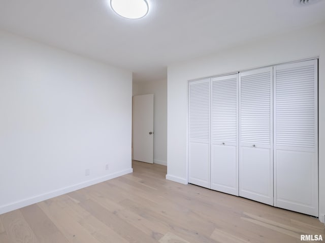 2810 Deveron Cir, Pekin, IL 61554 - unfurnished bedroom with light wood-style flooring and a closet
