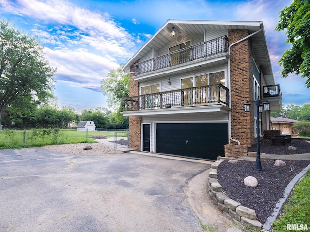 2810 Deveron Cir, Pekin, IL 61554 - view of front of property with a balcony, brick siding, driveway, and a garage
