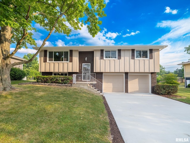 2922 W Larchmont Ln, Peoria, IL 61615 - raised ranch with brick siding, an attached garage, a front yard, driveway, and board and batten siding