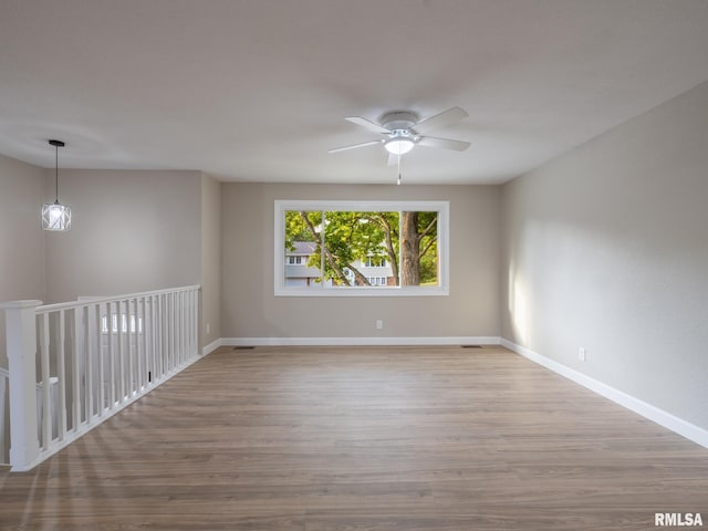2922 W Larchmont Ln, Peoria, IL 61615 - empty room with wood finished floors and ceiling fan