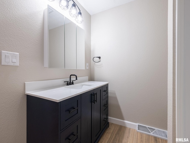 2922 W Larchmont Ln, Peoria, IL 61615 - bathroom featuring wood finished floors and vanity
