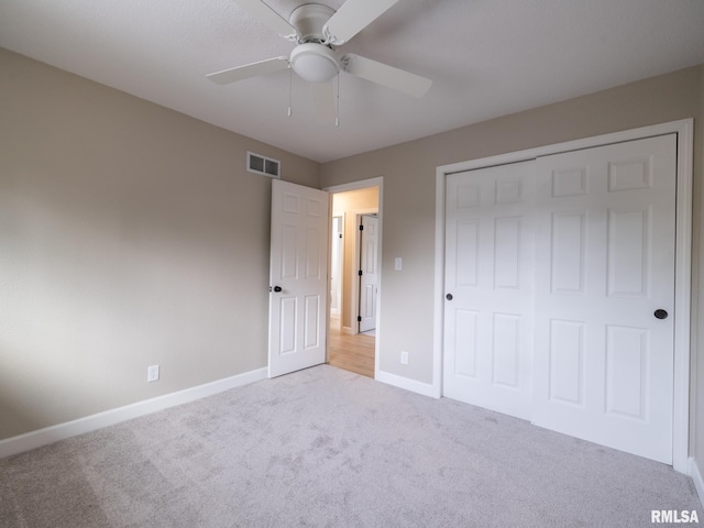 2922 W Larchmont Ln, Peoria, IL 61615 - unfurnished bedroom featuring carpet floors, a closet, and ceiling fan