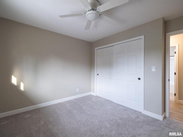 2922 W Larchmont Ln, Peoria, IL 61615 - unfurnished bedroom with carpet, a closet, and a ceiling fan