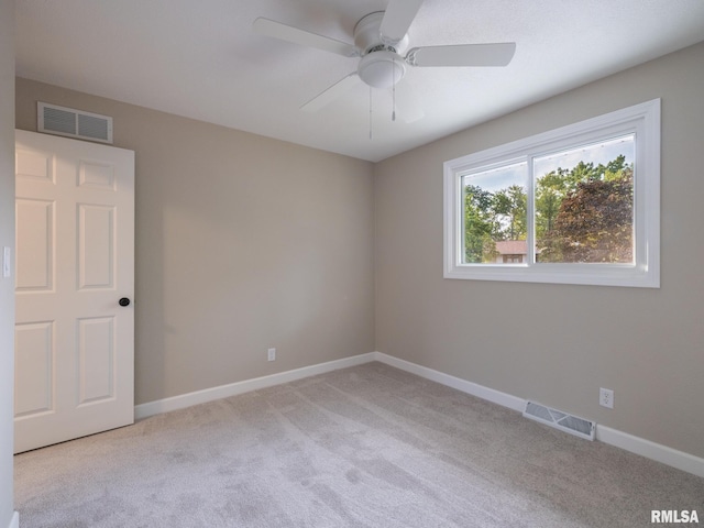 2922 W Larchmont Ln, Peoria, IL 61615 - empty room with light carpet and a ceiling fan