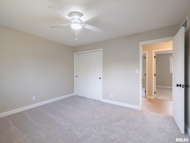 2922 W Larchmont Ln, Peoria, IL 61615 - unfurnished bedroom featuring carpet flooring, a closet, and a ceiling fan