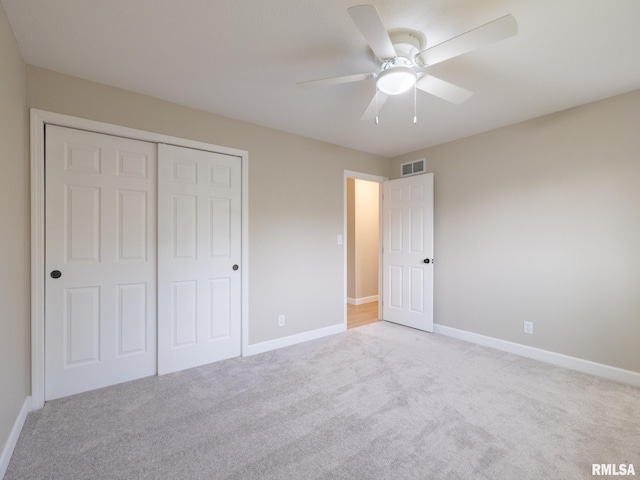 2922 W Larchmont Ln, Peoria, IL 61615 - unfurnished bedroom featuring light colored carpet, a closet, and a ceiling fan