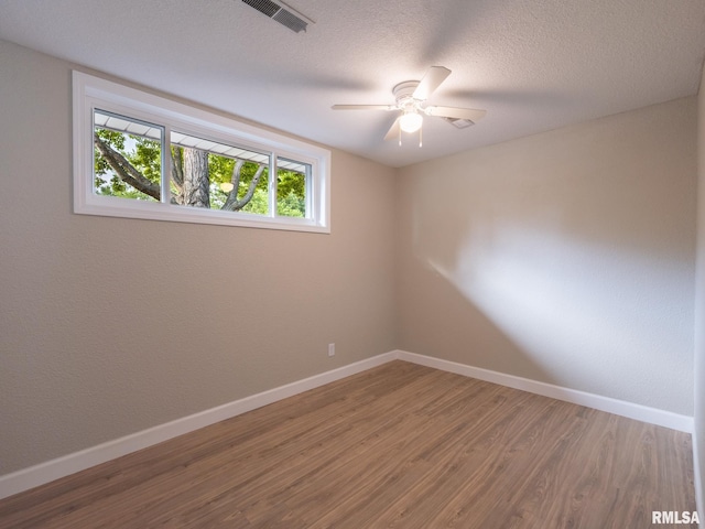 2922 W Larchmont Ln, Peoria, IL 61615 - empty room with wood finished floors, ceiling fan, and a textured ceiling