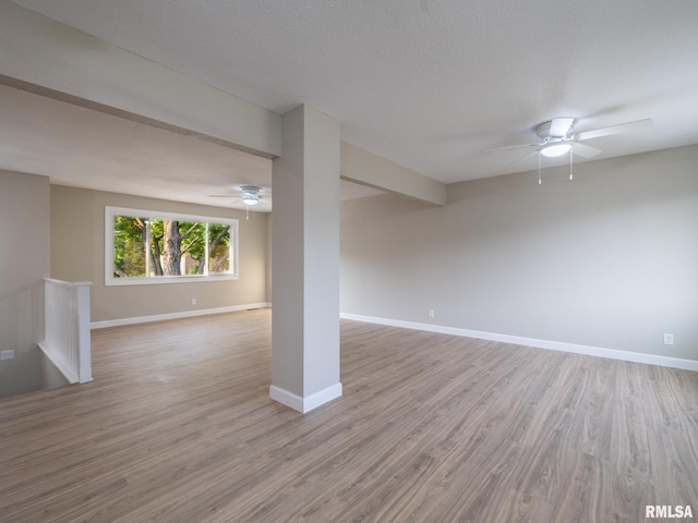 2922 W Larchmont Ln, Peoria, IL 61615 - below grade area with light wood-style flooring and a ceiling fan